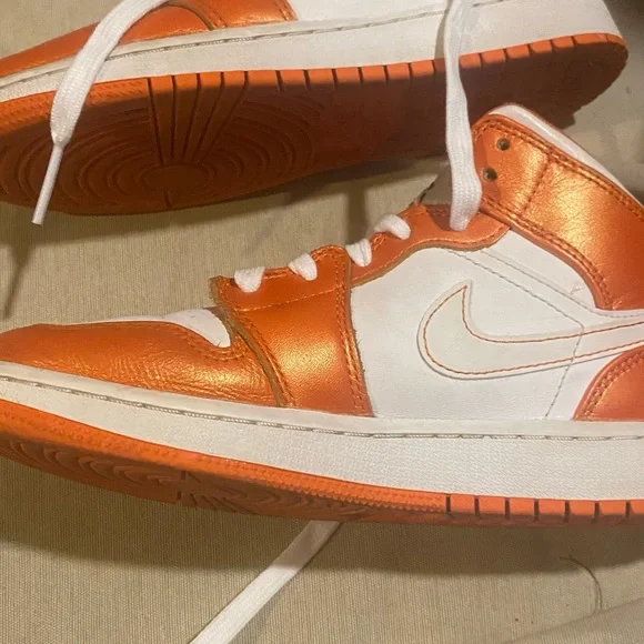 Nike mid 1 orange and white air Jordan.